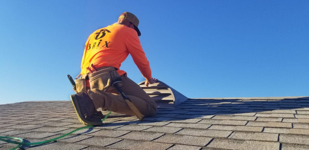 roofing contractor working on a shingle roof