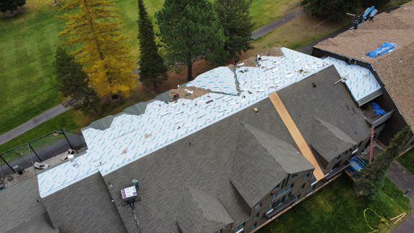 A new roof being installed, How Long Does a Roof Replacement Last in Montana?