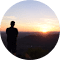 Image of person standing in sunset