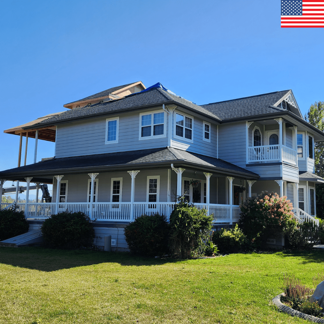 A house with a blue tarp and unfinished section of the roof