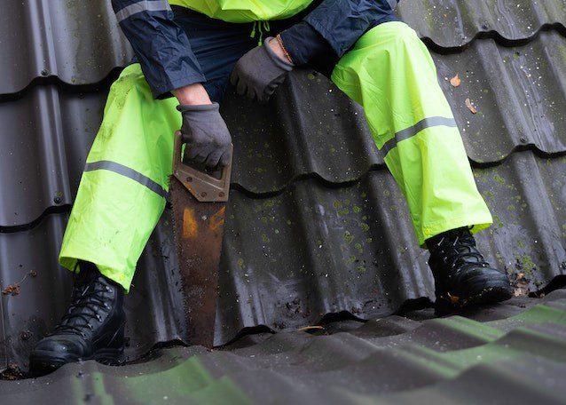 A roofer sitting on roof