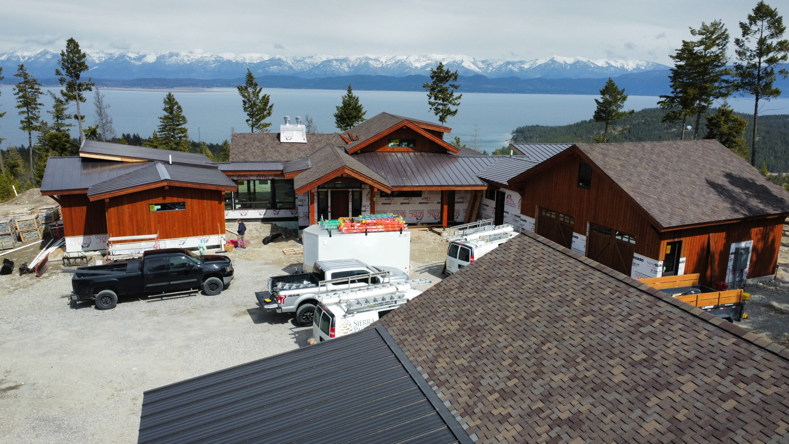house with metal and shingle roof with a beautiful mountain background