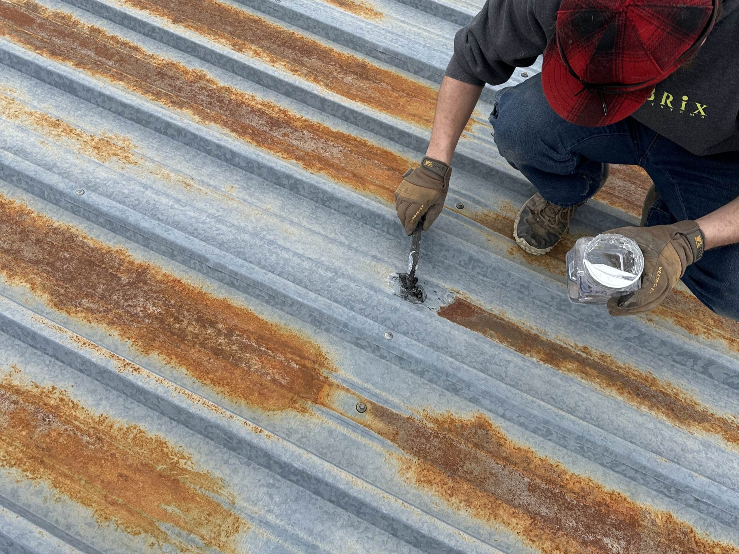 Brix Systems roofer repairing a metal roof