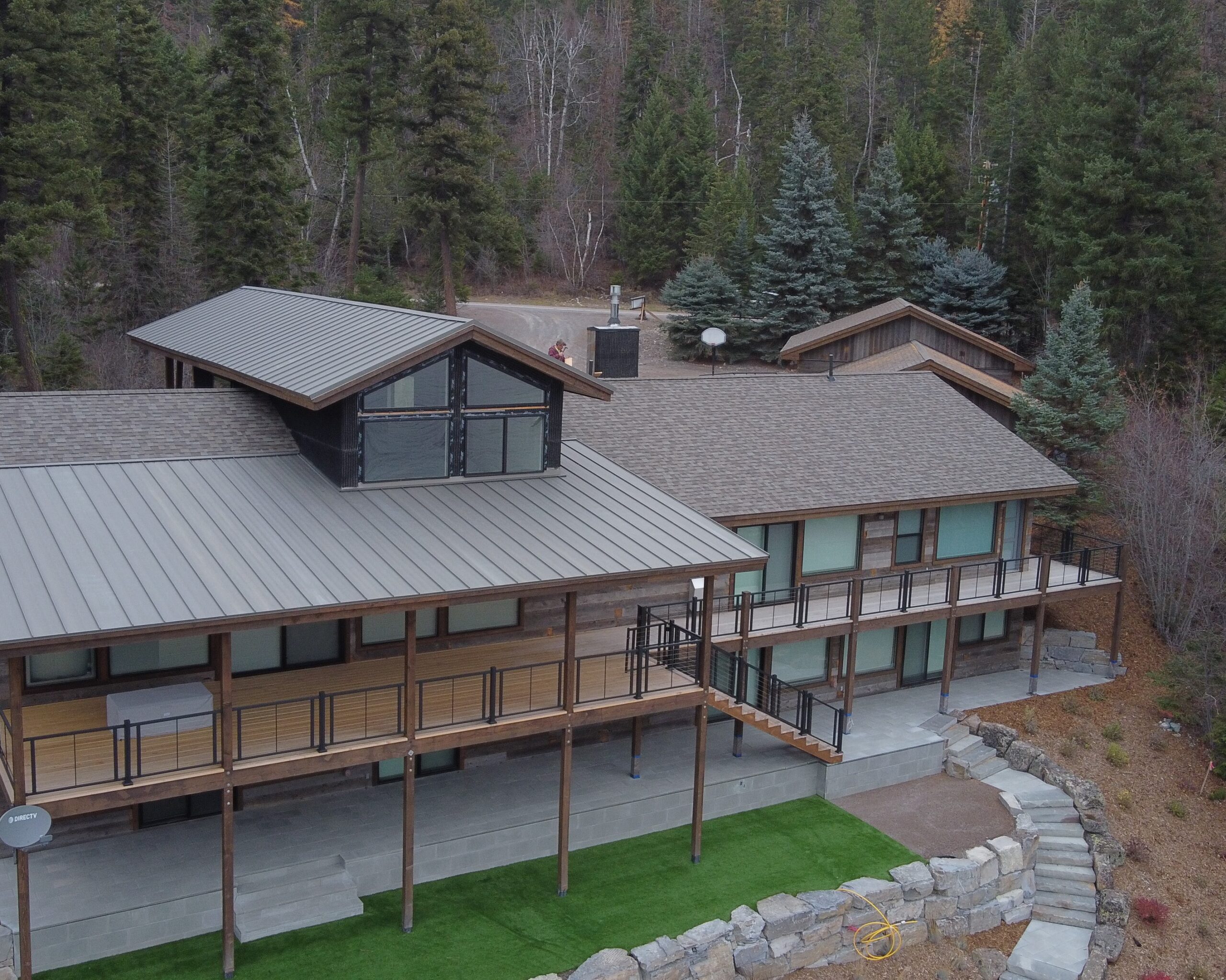 modern house in the flathead valley with a shingle and metal roof