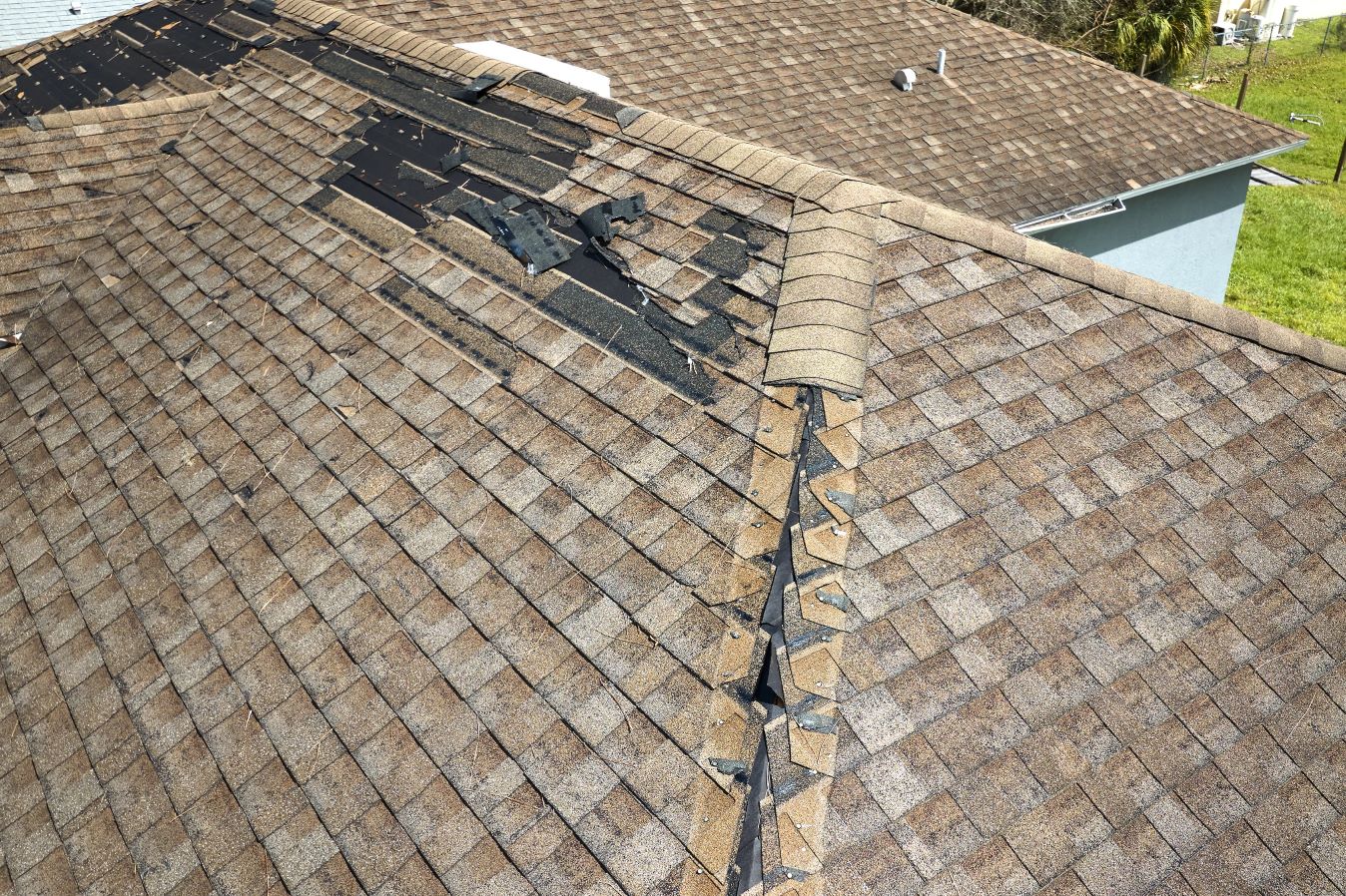 damaged roof with missing shingles
