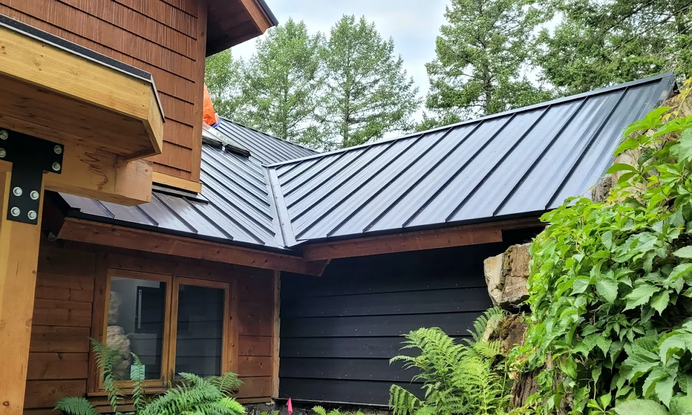 a metal roof on a residential house with wooden siding